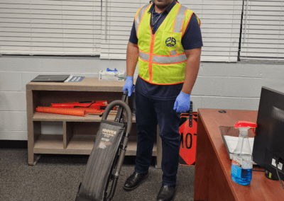 Custodial team member sweeping with vacuum cleaner